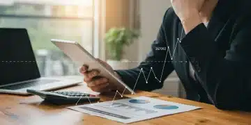 Person reviewing student loan documents with a smile, showing financial relief from the SAVE Plan.