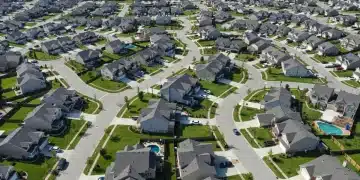 Modern suburban housing development with diverse homes and green lawns