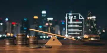 Balanza de justicia fiscal con monedas y documentos tributarios, simbolizando el impuesto a las grandes fortunas.